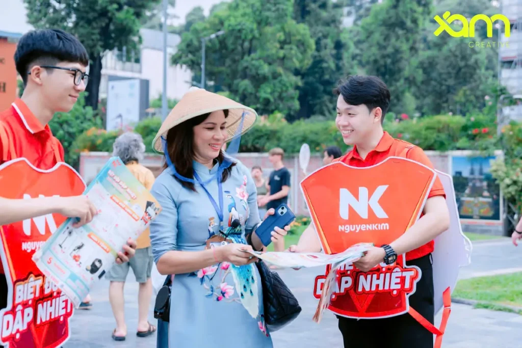 Walking billboard staff handing flyers to shoppers